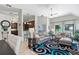 Beautiful, light-filled living room with tile floors, a modern rug, and neutral-toned furniture at 692 Greenglen Ln, Palm Harbor, FL 34684