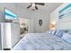 Relaxing main bedroom with a coastal theme, white furniture and a flatscreen tv for comfortable viewing at 692 Greenglen Ln, Palm Harbor, FL 34684