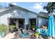 Inviting patio area with comfortable outdoor furniture, potted plants, and sliding glass doors at 692 Greenglen Ln, Palm Harbor, FL 34684