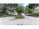 Street view of the neighborhood entrance sign with well-maintained landscaping and mature trees at 692 Greenglen Ln, Palm Harbor, FL 34684