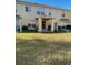 Backyard view featuring a covered patio, a green lawn, and the exterior of the home at 6954 Hawthorne Trace Ln, Riverview, FL 33578