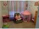 Playful bedroom with colorful decorations, toys, and a small tent at 6954 Hawthorne Trace Ln, Riverview, FL 33578