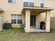 View of a covered back patio with a grill and sliding glass door leading inside at 6954 Hawthorne Trace Ln, Riverview, FL 33578