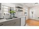 Kitchen featuring stainless steel sink, white dishwasher, neutral cabinets, and window overlooking outdoors at 6980 Avenue Des Palais # 2A, South Pasadena, FL 33707