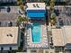 Aerial view of a community pool with lounge chairs, tables, and lush landscaping creating a relaxing oasis for residents at 6980 Avenue Des Palais # 2A, South Pasadena, FL 33707