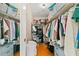 Organized walk-in closet featuring shelves and hanging rods for optimal storage at 6980 Avenue Des Palais # 2A, South Pasadena, FL 33707