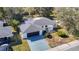 Aerial view of single-story home with a black garage door and a gated front entrance at 714 Lemonwood Dr, Oldsmar, FL 34677