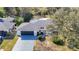 Aerial view of single-story home with a black garage door and a gated front entrance at 714 Lemonwood Dr, Oldsmar, FL 34677