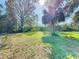 Fenced backyard with mature trees providing privacy and shade at 714 Lemonwood Dr, Oldsmar, FL 34677