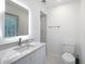 Well-lit bathroom with a marble countertop and walk-in shower at 714 Lemonwood Dr, Oldsmar, FL 34677