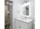 Modern bathroom with a lighted mirror and marble countertop at 714 Lemonwood Dr, Oldsmar, FL 34677