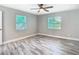 Bedroom with new flooring, windows, modern ceiling fan and neutral colored walls at 714 Lemonwood Dr, Oldsmar, FL 34677