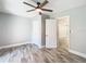 Bedroom with closet and open door; shows modern ceiling fan and luxury vinyl plank flooring at 714 Lemonwood Dr, Oldsmar, FL 34677