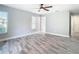 A bedroom with large window and gray floors at 714 Lemonwood Dr, Oldsmar, FL 34677