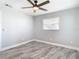 This bedroom features a modern ceiling fan and sleek gray flooring at 714 Lemonwood Dr, Oldsmar, FL 34677