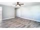 Bedroom features a closet with bi-fold doors, modern fan and new luxury vinyl plank flooring at 714 Lemonwood Dr, Oldsmar, FL 34677