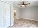 View of bedroom with modern ceiling fan, open doorway, closet, and attractive flooring at 714 Lemonwood Dr, Oldsmar, FL 34677