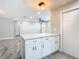 Kitchen island with white cabinets and granite countertops open to the living room at 714 Lemonwood Dr, Oldsmar, FL 34677