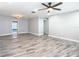 Open-concept living room with modern wood-look floors and a ceiling fan at 714 Lemonwood Dr, Oldsmar, FL 34677