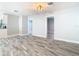 Open-concept living space featuring modern flooring and neutral paint, leading to bedrooms and the kitchen at 714 Lemonwood Dr, Oldsmar, FL 34677