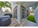 Back porch with grill and outdoor kitchen, surrounded by green artificial turf at 7325 S Trask St, Tampa, FL 33616