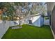 Green backyard features a tree swing and white fence along the perimeter of the property at 7325 S Trask St, Tampa, FL 33616