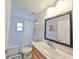 Bright bathroom features a shower-tub combo, a mirror, and a vanity sink at 7325 S Trask St, Tampa, FL 33616