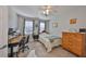 Cozy bedroom features a ceiling fan, a workstation desk and a classic wood dresser at 7325 S Trask St, Tampa, FL 33616