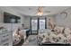 Sunlit bedroom features hardwood floors, a ceiling fan, and neutral paint, making it a comfortable space at 7325 S Trask St, Tampa, FL 33616