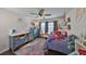 A bedroom with ceiling fan, dresser, dark floors, and a bed at 7325 S Trask St, Tampa, FL 33616