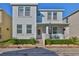 Charming two-story home featuring a cozy front porch, decorative landscaping, and a freshly painted facade at 7325 S Trask St, Tampa, FL 33616