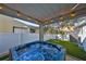 Backyard hot tub with view of artificial turf and swing beneath shade tree at 7325 S Trask St, Tampa, FL 33616