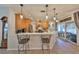 Modern kitchen with stainless steel appliances, quartz countertops, and an island with breakfast bar seating at 7325 S Trask St, Tampa, FL 33616