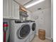 This laundry room has a washer and dryer and is complete with storage cabinets at 7325 S Trask St, Tampa, FL 33616