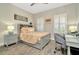 Cozy bedroom with shuttered windows, gray furniture, and wood-look tile floors at 7426 Sungold Meadow Ct, Apollo Beach, FL 33572