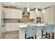 Bright and spacious kitchen with a center island, pendant lighting, tile backsplash, and ample counter space at 7426 Sungold Meadow Ct, Apollo Beach, FL 33572