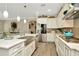 Well-equipped kitchen featuring white cabinetry, granite countertops, stainless steel appliances, and a stylish tile backsplash at 7426 Sungold Meadow Ct, Apollo Beach, FL 33572