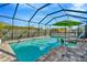 Inviting screened-in pool area featuring a sparkling pool, ample deck space, and a lush, private backyard setting at 7426 Sungold Meadow Ct, Apollo Beach, FL 33572