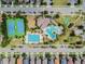 Aerial view featuring community pool, tennis courts, clubhouse, and meticulously landscaped grounds at 7645 Windchase Way, Wesley Chapel, FL 33545