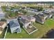 An aerial view of a home with a white picket fence and a pond in the backyard at 7645 Windchase Way, Wesley Chapel, FL 33545