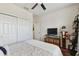 Well-lit bedroom with hardwood floors, ceiling fan, and ample closet space at 7645 Windchase Way, Wesley Chapel, FL 33545