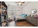 Bright bedroom with wooden dresser, bookshelf, and natural light at 7645 Windchase Way, Wesley Chapel, FL 33545