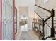 Bright foyer with tile flooring, staircase, and a view into the living room at 7645 Windchase Way, Wesley Chapel, FL 33545