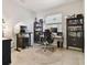 This home office features two desks, plenty of shelving, and natural light from the window at 7645 Windchase Way, Wesley Chapel, FL 33545