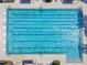 Aerial view of a rectangular community pool with multiple lanes, surrounded by a deck with lounge chairs at 7645 Windchase Way, Wesley Chapel, FL 33545