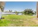 Expansive backyard with lush green grass, waterfront views, and a private dock at 8705 Tahiti Ln, Tampa, FL 33615