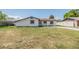 Well-kept front yard showing the home's exterior with a green lawn and a driveway at 8705 Tahiti Ln, Tampa, FL 33615