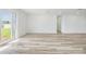 Bright living room featuring modern flooring, fresh white walls, and natural light from a glass sliding door at 8705 Tahiti Ln, Tampa, FL 33615