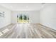 Bright, airy room with sleek flooring, neutral walls, and sliding doors to the backyard at 8705 Tahiti Ln, Tampa, FL 33615