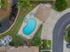 Aerial view of the community pool, landscaping, and nearby waterway; a gorgeous Florida oasis at 9012 Antigua Dr, Seminole, FL 33777